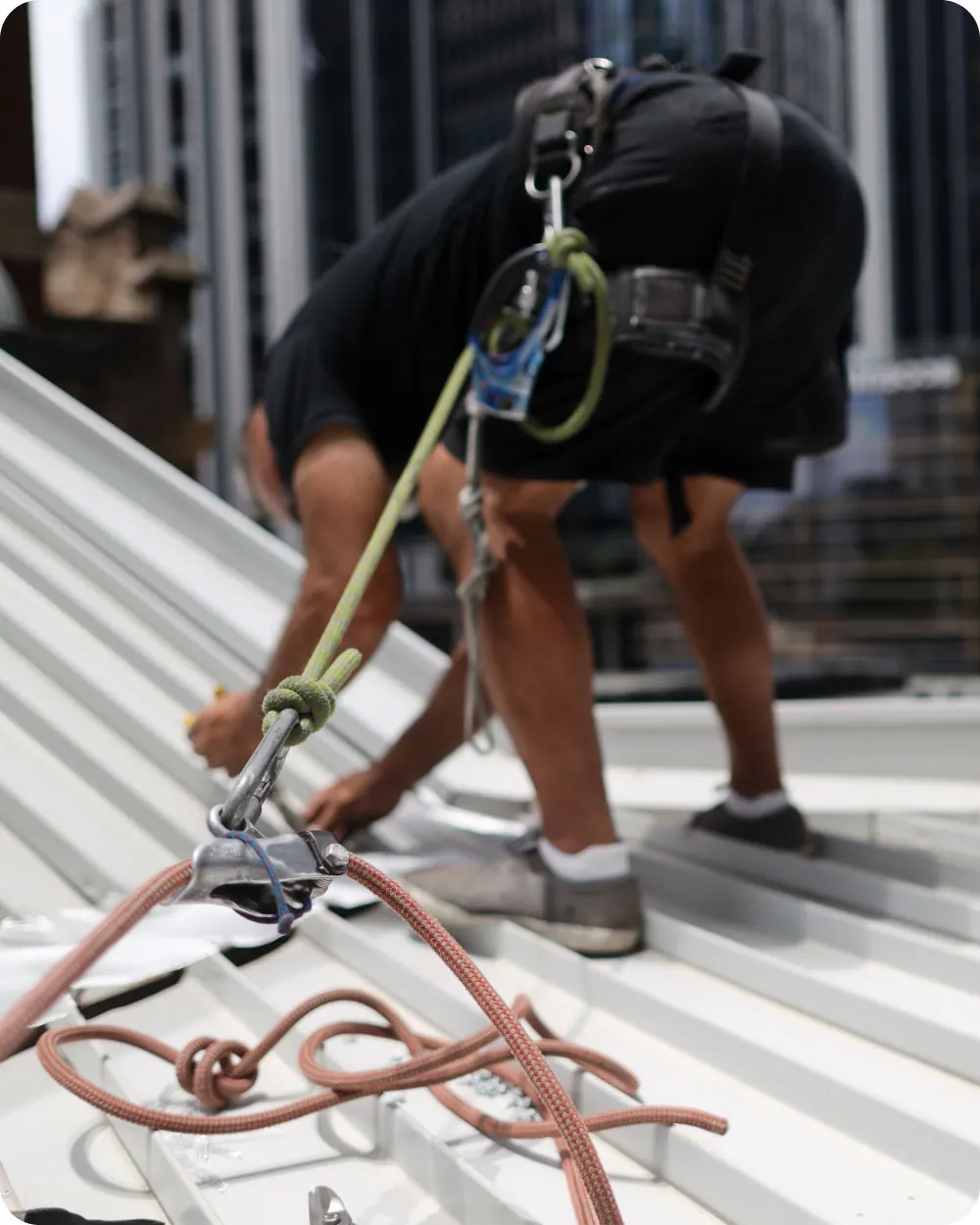 Crossy's roofer working safely at height with harness equipment